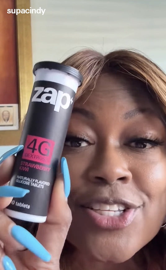 A customer holding a Strawberry Kiwi tube of Zap