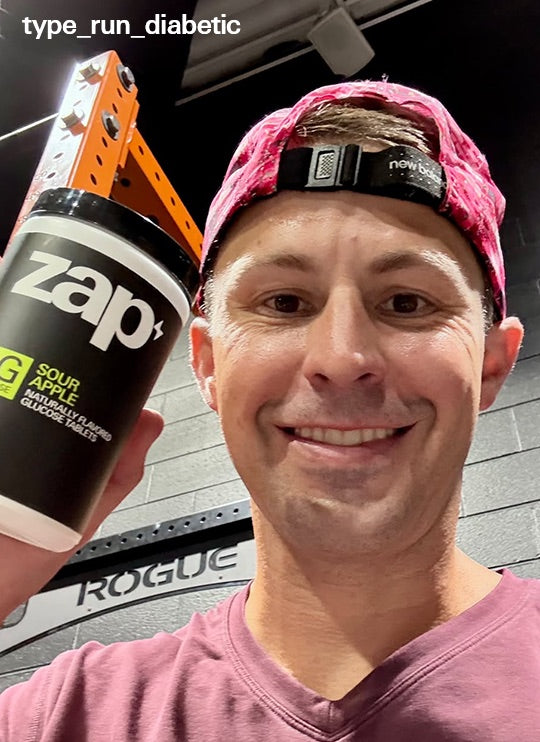 A runner at the gym holding a Sour Apple jar of Zap